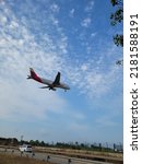 Small photo of BARCELONA, SPAIN - 23th of July 2022: Iberia airplane landing in Barcelona- El Prat Airport. Iberia is a spanish airline. Views from "El Delta del Llobregat"