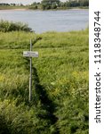 Small photo of Netherlands,Holland,Dutch,Gelderland, Bommelerwaard,Zaltbommel,july 2017: Sign temerarious at riverbank of river Waal