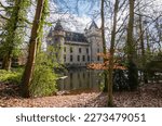 Castle of Zellaer behind trees in Belgium park. Neo Gothic architecture.	