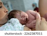 childbirth. Mother and newborn. The birth of a child in a maternity hospital. A young mother hugs her newborn baby after giving birth. Childbirth woman. The first moments of a child's life after child