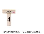 July 4 displayed wooden letter blocks on white background with space for print. Concept for independence day.