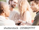Small photo of A captivating moment unfolds as a Caucasian man and woman share a deep, flirtatious connection at the dinner table of an evening garden party, nearly sharing a kiss. Amidst the cheerful chatter and