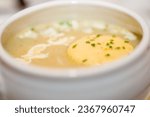 Small photo of Indulge in the richness of this creamy soup, where flavors meld in perfect harmony. A delectable piece of butter gently floats on the surface, promising a luxurious culinary experience. Savory Delight