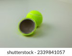 Small photo of Tennis ball cut in half. The hemisphere of a rubber ball for sports is divided into two parts and a whole ball for tennis