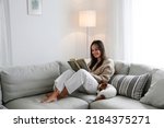 Young beautiful woman reading a ...
