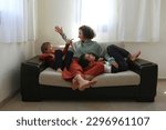Adult woman enjoying weekend at home and spending quality time with her two sons. Indoor activity with children concept. Close up, copy space, background.