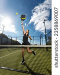 Small photo of Padel tennis player with racket in action on the court. Woman athlete with paddle racket on court outdoors. Sport concept. Download a high quality photo for the design of a sports app or web site.