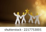 Small photo of Successful Teamwork Concepts. Paper Cut as Group of Worker Raise Up a Star Together. Business Strategy. Working to Committed and Towards a Shared Goal. Colleagues or Partnership Celebrating a Success