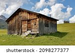 Small photo of Traditional wooden mountain hut in the Austrian Alps with old rake and pitchfork. Lech, Arlberg, Austria.