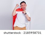 Small photo of Young Asian man clenched both fist to celebrate Indonesia independence day on August 17, looking at camera with confident and excited expression isolated on white background