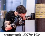 Small photo of HELSINKI, FINLAND – NOVEMBER 11 2021: Professional boxer Jose Antonio Sanchez Romero punching the heavy bag at Ringside Gym