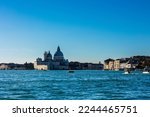 Basilica of Saint Mary of Health (Basilica di Santa Maria della Salute) with Venice canal waters, buildings and gondolas during winter 2022
