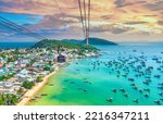 The longest cable car ride in the world, Phu Quoc island in South Vietnam, sunset sky. Below is traditional fishermen boats lined in the harbor of An Thoi town in the popular Hon Thom island. 