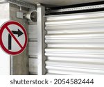 Small photo of Strikethrough red and white Right Turn Sign on Iron Wall Background.