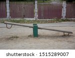 Small photo of Old teeter-totter on an abandoned playground on the promenade in the city