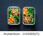 Healthy balanced lunch box. Grilled chicken zucchini burgers with broccoli, pumpkin, green pea salad on a dark background, top view. Office food lunch healthy lifestyle concept    