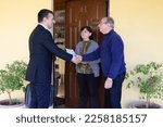 Small photo of Image of a sales rep and door-to-door salesman explaining his products for sale to an older couple. Harassing seller and scammer.