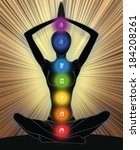 Woman silhouette in yoga position with the symbols of seven chakras 