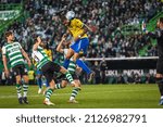 Small photo of Lisbon, Portugal - 02 20 2022: Liga Bwin game between Sporting CP and Estoril Praia, Estadio Jose Alvalade; Rosier heads the ball and Adan defends