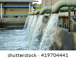 Water flows from a pipe for cooling of machine.