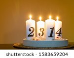 Advent candlestick with all four white numbered candles lit fourth advent 