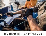 Small photo of Man's hand with boat rope. Yachtsman moors his motor boat at jetty. Close up hands and bow of the boat.