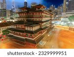 Small photo of Buddha Tooth Relic Temple in Singapore's Chinatown district transforms into a captivating spectacle at night, radiating gentle golden light. Its intricate architectural elements exude a heavenly charm