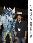 Small photo of A replica of a Kaiju creature with builder Fon Davis at Stan Lee's Comikaze Expo in Los Angeles, California, October 2014.
