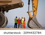 Workers Talking By Machinery In ...