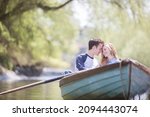 Couple Sitting In Rowboat On...