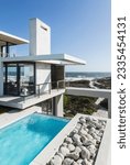 Small photo of Lap pool and balcony of modern house overlooking ocean