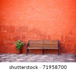 Long Chair Against Red Wall
