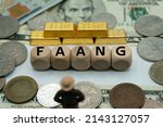 “FAANG” is an acronym that refers to the stocks of five prominent American technology company.widely known among consumers,The word is written,on  money and gold background