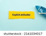 Small photo of Explicit attitudes.The word is written on a slip of colored paper. Psychological terms, psychologic words, Spiritual terminology. psychiatric research. Mental Health Buzzwords.