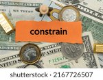 Small photo of constrain.The word is written on a slip of paper,on colored background. professional terms of finance, business words, economic phrases. concept of economy.