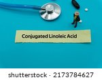 Small photo of Conjugated Linoleic Acid.The word is written on a slip of colored paper. health terms, health care words, medical terminology. wellness Buzzwords. disease acronyms.