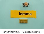 Small photo of lemma.The word is written on a slip of paper,on colored background. professional terms of finance, business words, economic phrases. concept of economy.