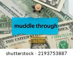 Small photo of muddle through.The word is written on a slip of paper,on colored background. professional terms of finance, business words, economic phrases. concept of economy.