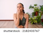 Small photo of A young woman meditates with alternate nostril breathing to calm anxiety