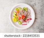 Fresh salad with onion, cucumber, carrot, lemon and tomato served in a plate isolated on background top view of indian and pakistani desi food