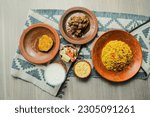 Small photo of Haash Bhuna Khichuri Combo with egg plant, korma karahi, meat, salad, borhani and firni served in dish isolated on mat top view of indian and bangladeshi food