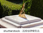 Small photo of Beautiful Golden twisted pointer or gnomon of sundial casts shadow on dial. Russia, St. Petersburg 28 August 2022 vintage sundial gilding, ancient science and engineering, time measurement instrument