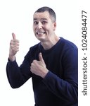 Small photo of Figure of fun. Funny lucky man wtih ardent body language. Isolated on white background. Man showing be number one gesture. Joyful man making funny baboonery. Man showing thumbs-up. The lucky one