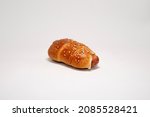 Small photo of Sicilian rotisserie - Rollo. Piece of rotisserie with sausage on white background and light on it.