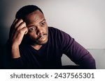 Small photo of Portrait of contemplative African American man struggling with inner turmoil and emotional distress