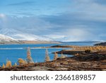 Small photo of Russia. Magadan Region. Beautiful Lake Momontay against the backdrop of a snowy mountain range. Late autumn in the vicinity of Lake Momontay.