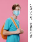 Small photo of highly blurred beyond recognition portrait of a man in bright clothes and with a medical mask on his face