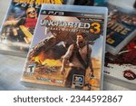 Small photo of Uncharted 3 Drake's Deception PlayStation game CD at the flea market. Ankara, Turkey - August 6, 2023.