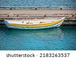 Small Yellow Rowboat Tied To...