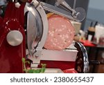 Small photo of Mortadella ready to be cut on a professional slicer